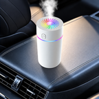 White cylindrical USB humidifier with multicolor lighting releasing mist in a car interior