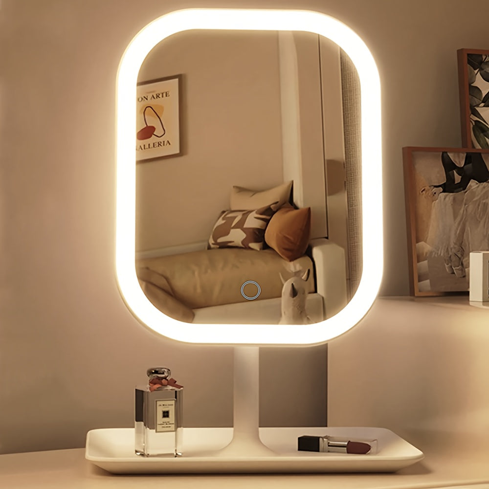 White vanity makeup mirror shown with warm light and cosmetics on its base.