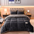 Dark gray velvet plush comforter on a bed