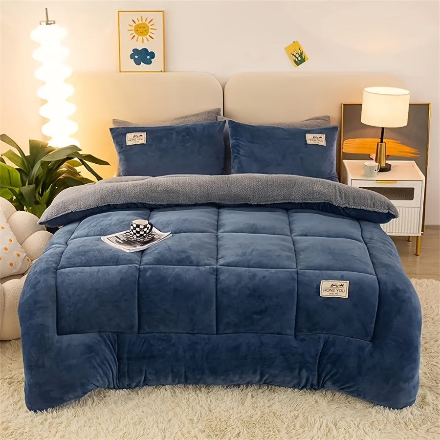 Blue velvet plush comforter displayed on a bed