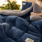 Blue plush comforter rolled to show the reverse