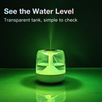 Green humidifier showing its transparent water tank against a green wall
