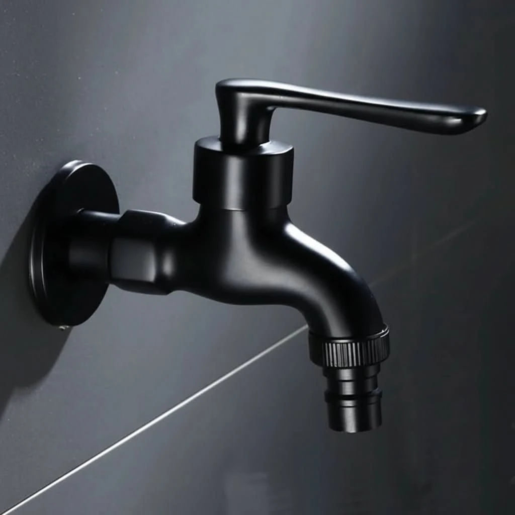 Wall-mounted faucet in a rounded matte black style with a hose connector against dark tile.