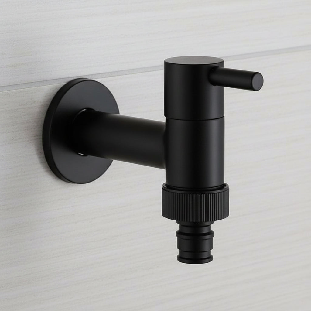 Wall-mounted faucet in a round matte black style mounted on a pale wall.