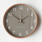 Gray wall clock with white numerals in a round wood frame