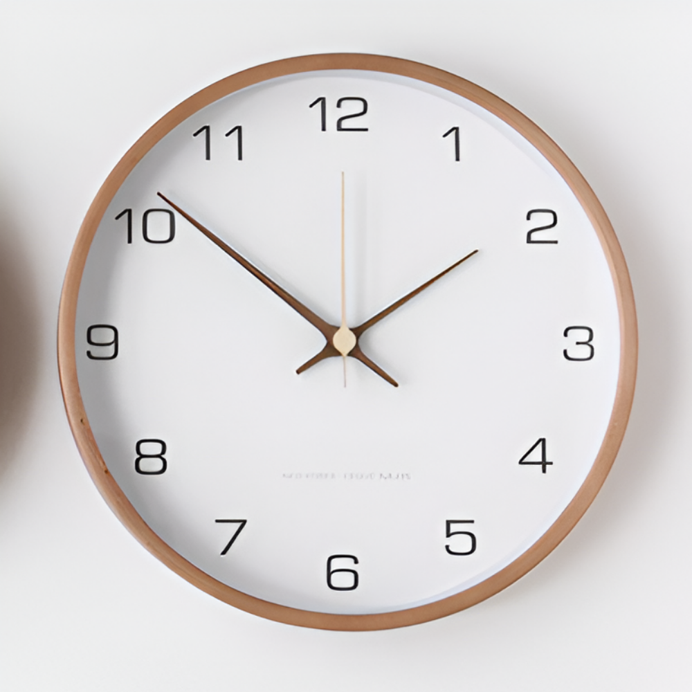 White wall clock with black numerals and a round wooden frame
