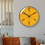 Black frame Nordic wall clock shown in a room.