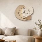 Beige wall clock with an abstract rounded face hangs above a softly styled living room sofa.