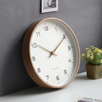 Wooden wall clock with natural frame and clear hands.