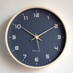 Blue Scandinavian wall clock with wood frame.