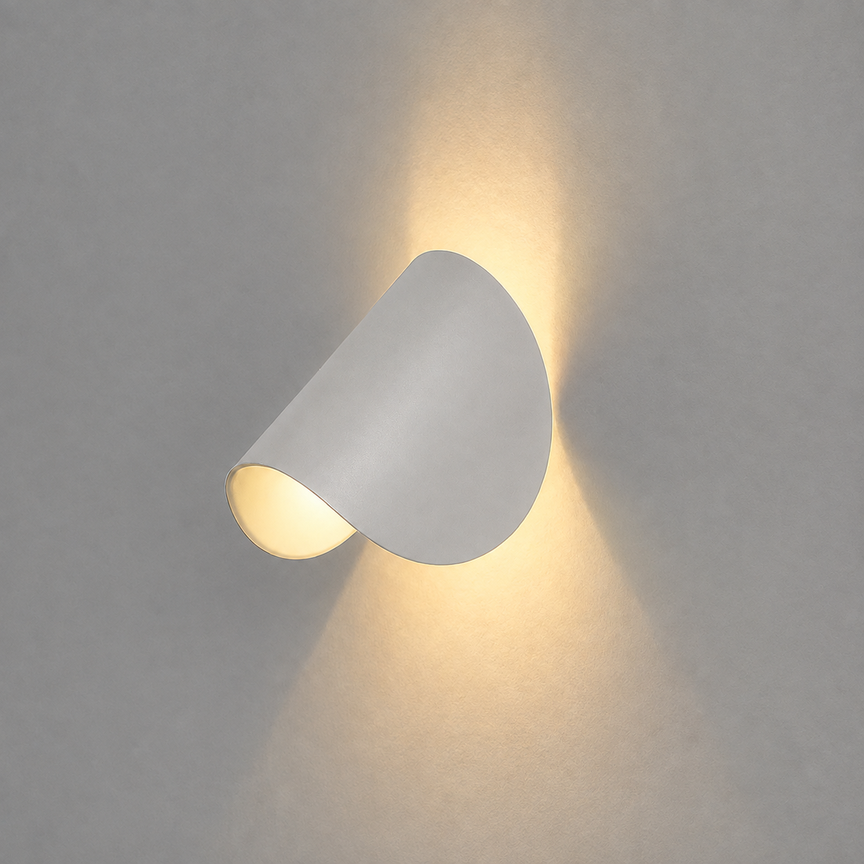 White wall lamp mounted on a light gray wall, casting a warm up-and-down beam.