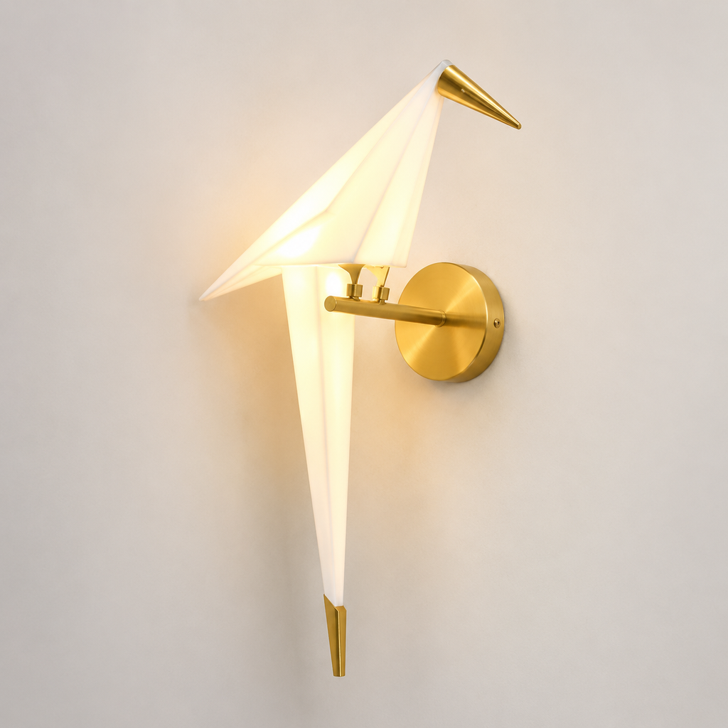Origami bird LED wall lamp glowing warm white with a translucent acrylic shade and brushed gold mount.