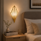 Geometric LED wall lamp glowing warm white above a wooden table with a mug, book, and smartphone.