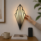 Geometric LED wall lamp glowing warm white above a wooden table with a mug, book, and smartphone.