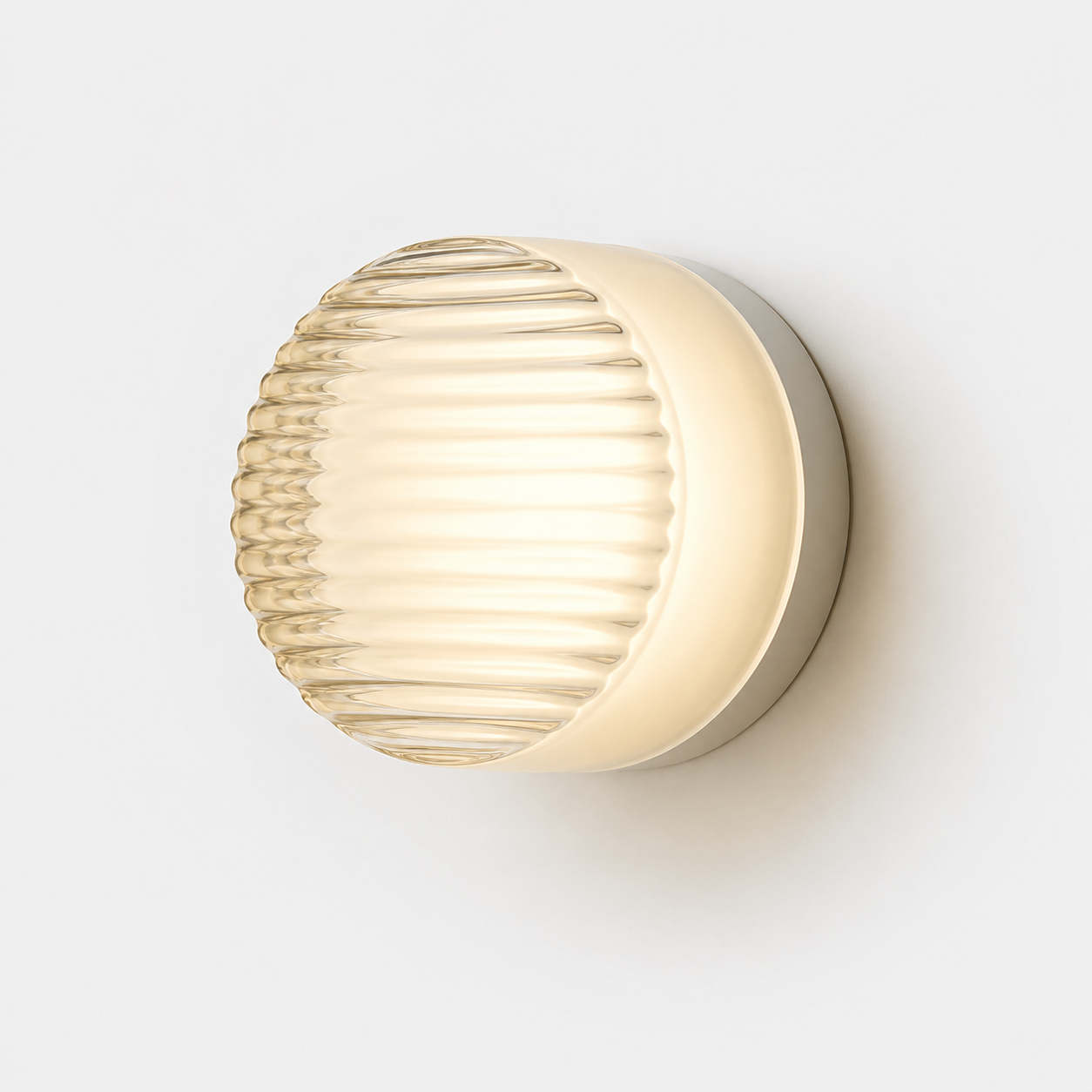 Round ribbed acrylic LED wall lamp glowing warm white against a white wall.