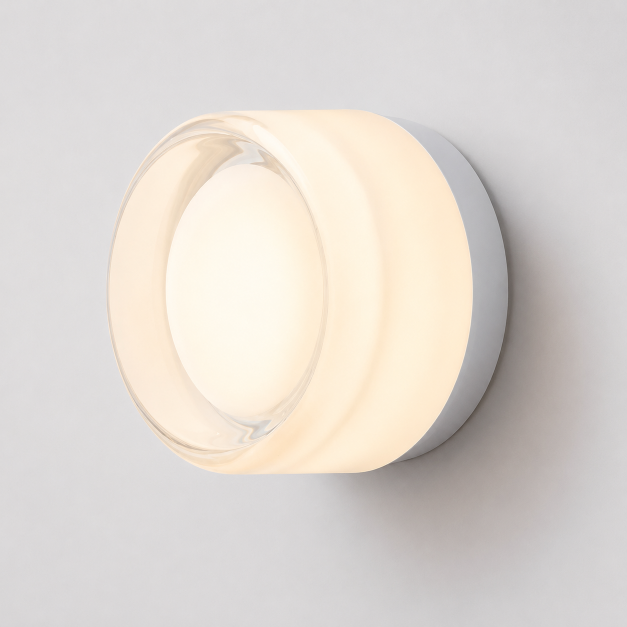 Round acrylic LED wall lamp glowing warm white against a neutral wall.