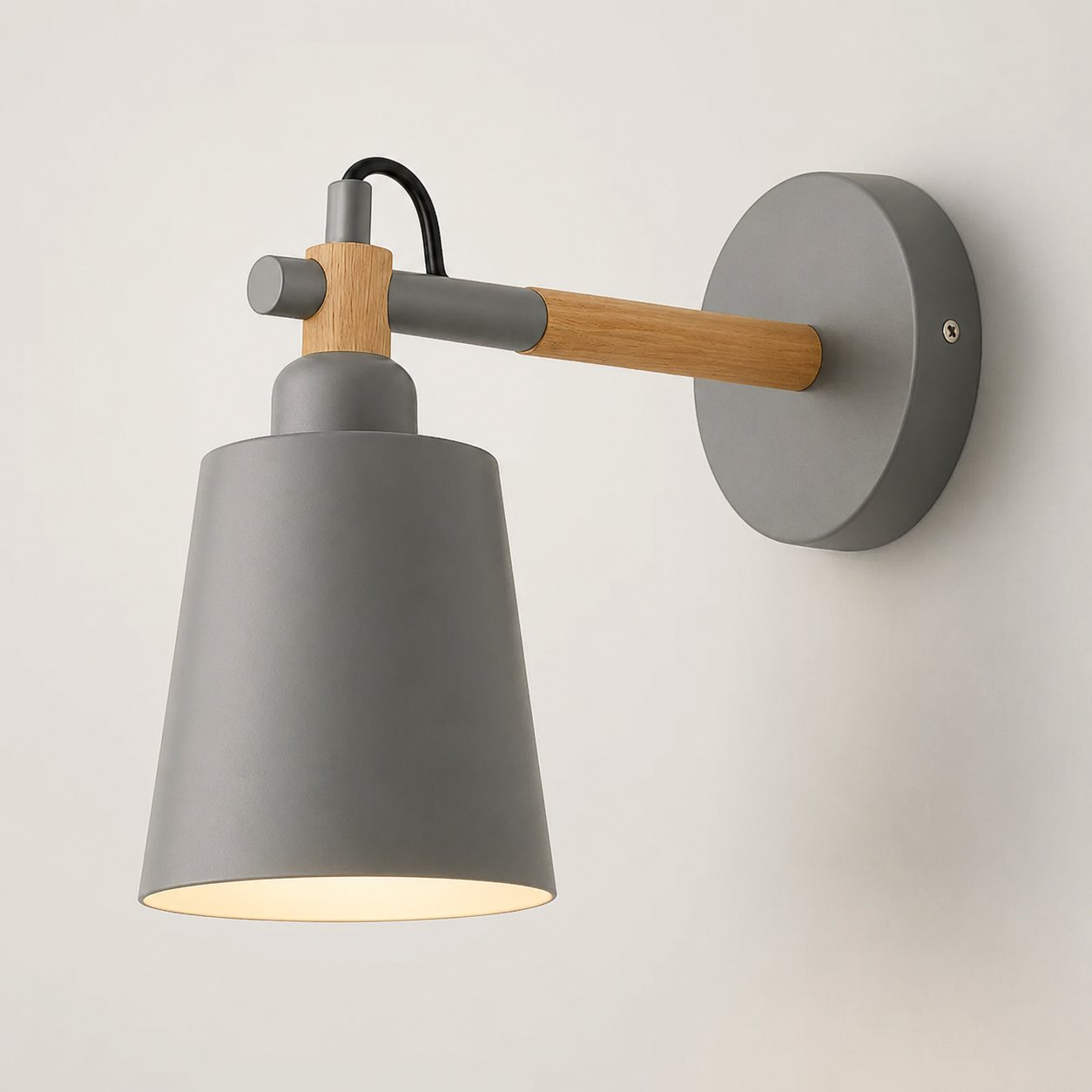 Scandinavian cone LED wall lamp with a solid wood arm, glowing warm white against a neutral wall.