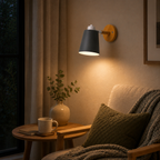 Adjustable cone wall lamp with a solid wood mounting base, glowing warm white against a neutral wall. 