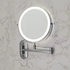 Folding arm magnifying wall mirror in bathroom