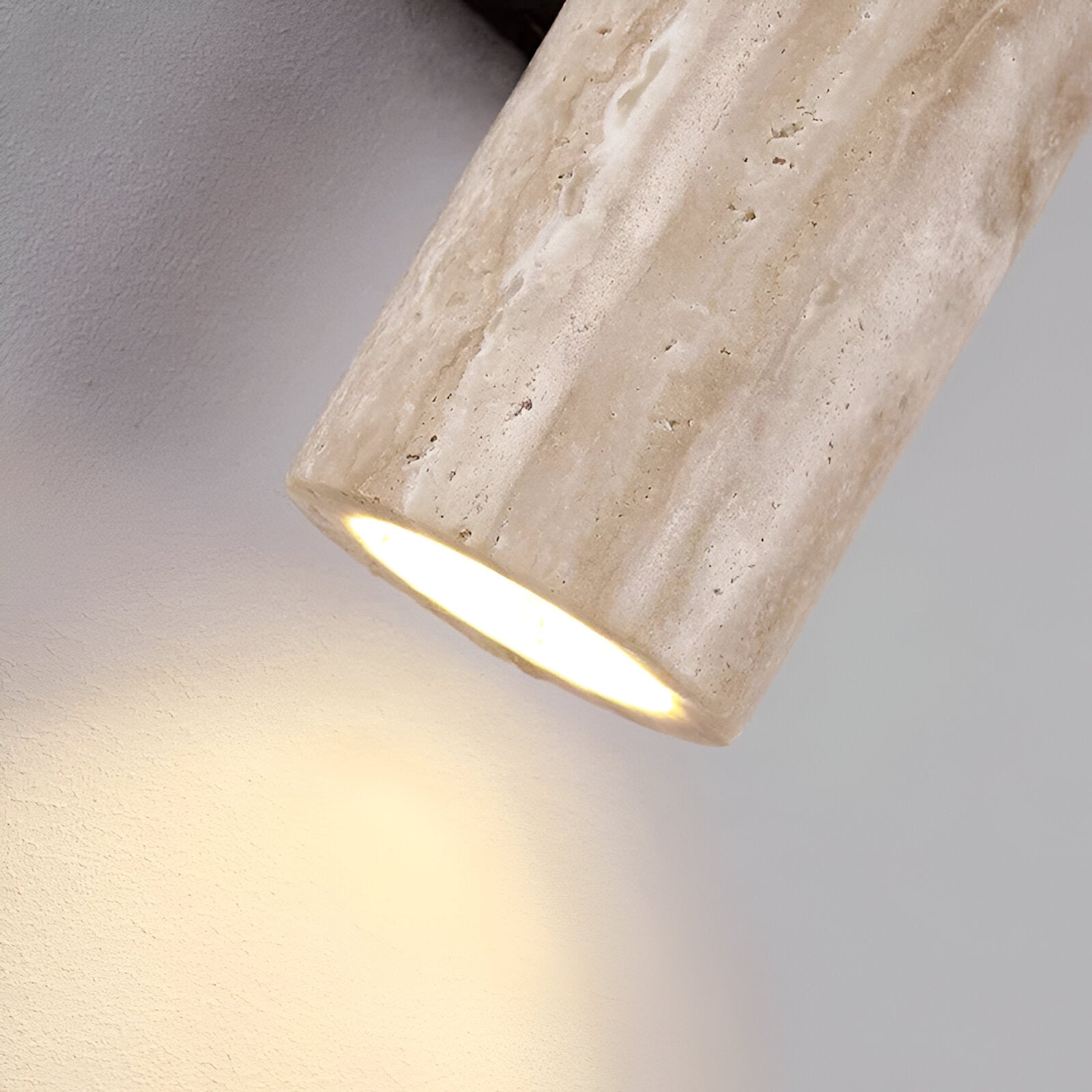 Wall sconce detail showing the open travertine shade