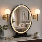 Pair of gold globe wall sconces flanking an illuminated mirror.