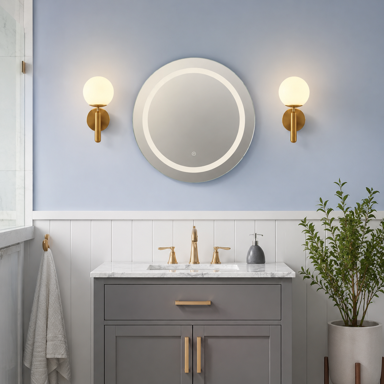 Two gold frosted globe wall sconces above a bathroom vanity.