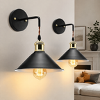 Two black industrial wall sconce fixtures glowing in a modern living room.