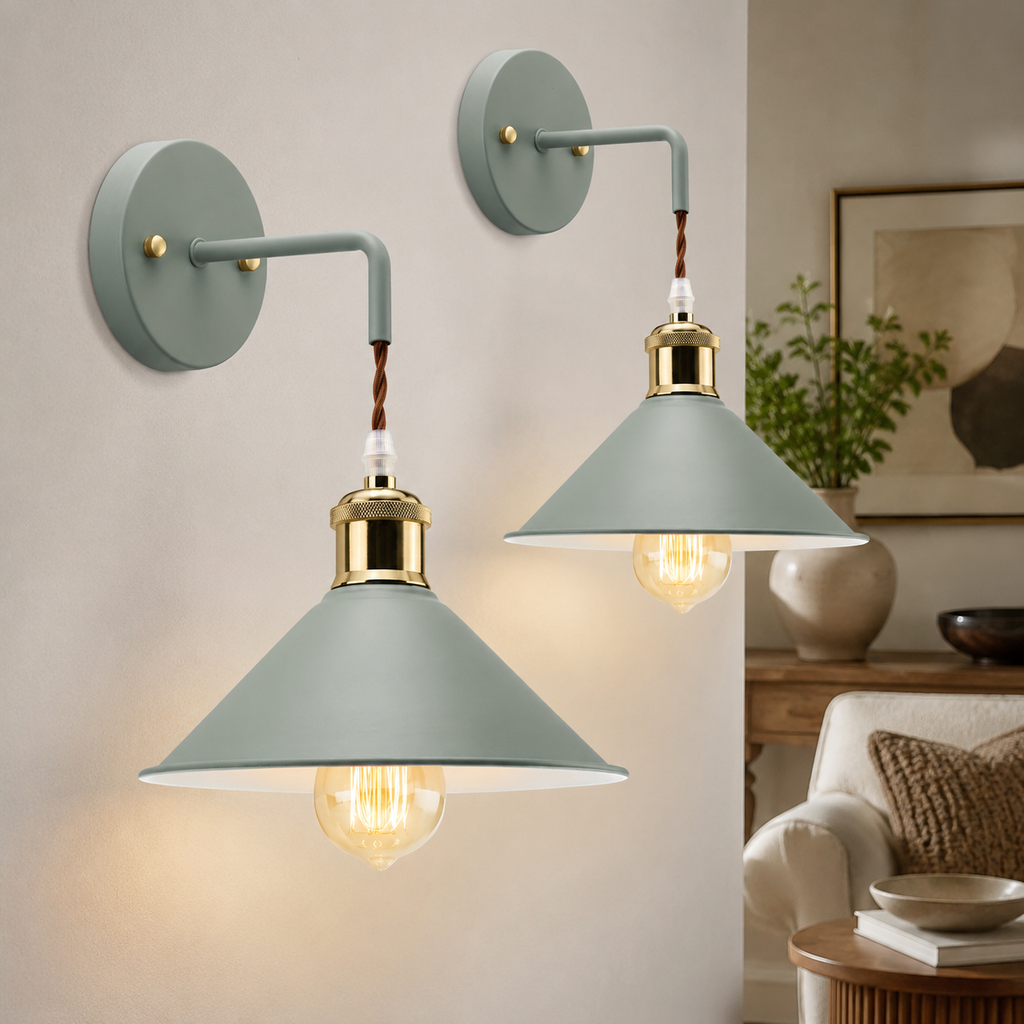 Two sage green industrial wall sconce fixtures glowing in a neutral room.