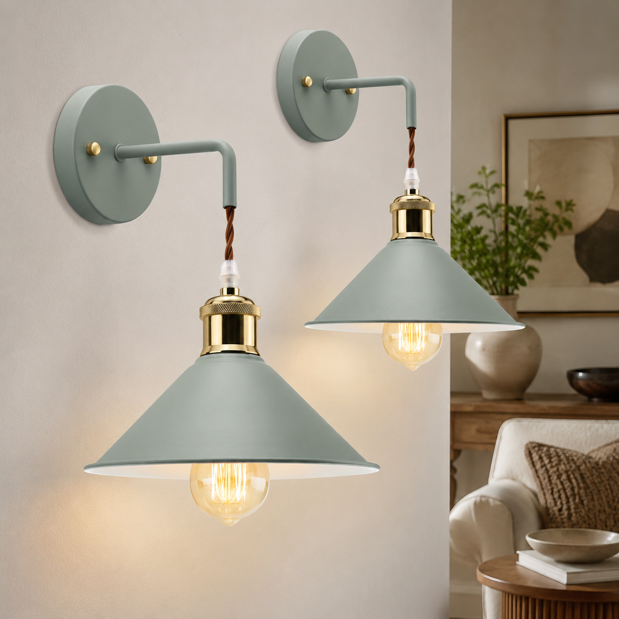 Two sage green industrial wall sconce fixtures glowing in a neutral room.