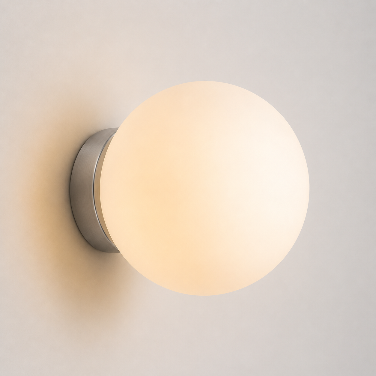 Warm-lit round wall sconce shown front-on against a light neutral wall.