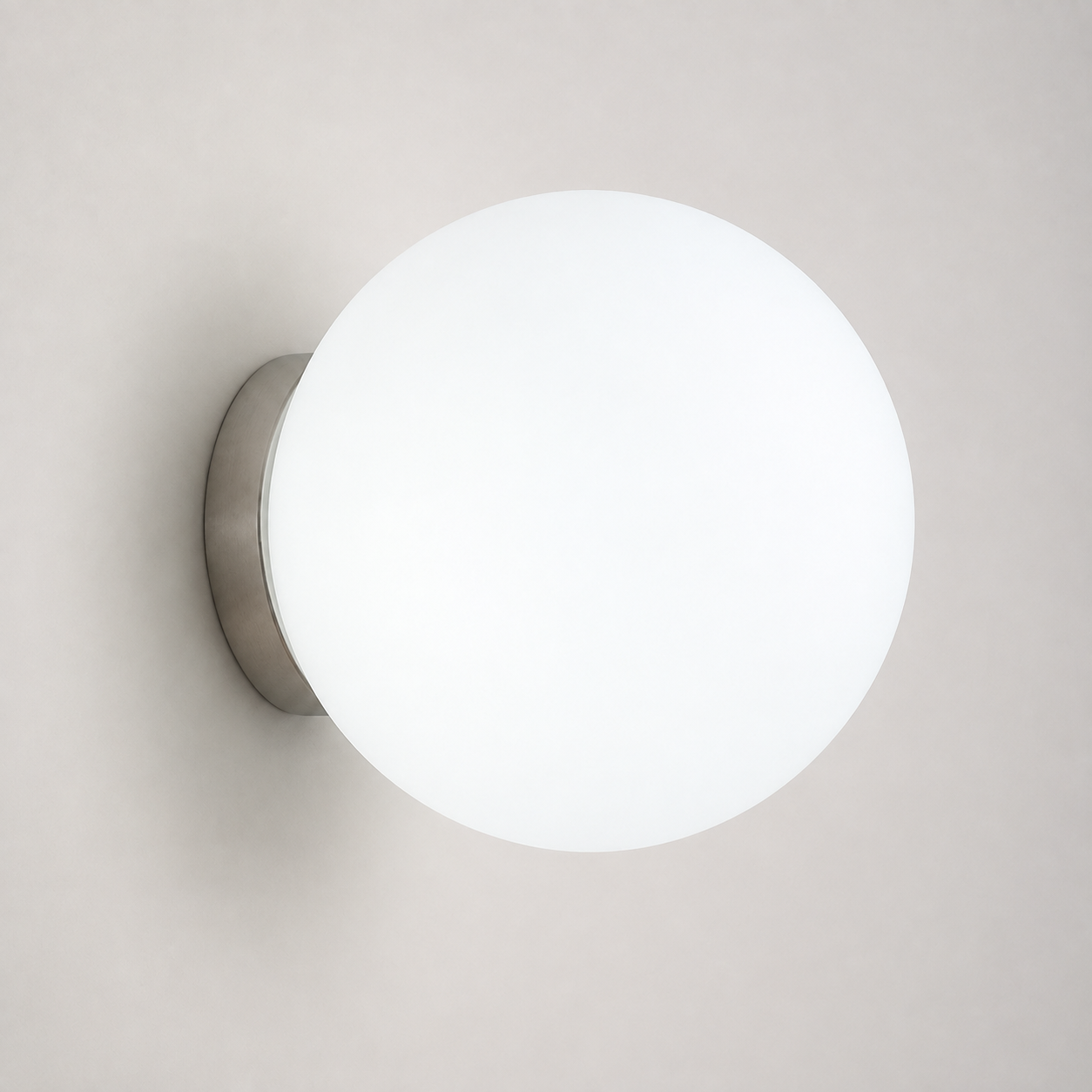 White-lit round wall sconce shown front-on against a light neutral wall.