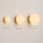 Three round wall sconce sizes are displayed side by side on a light background.