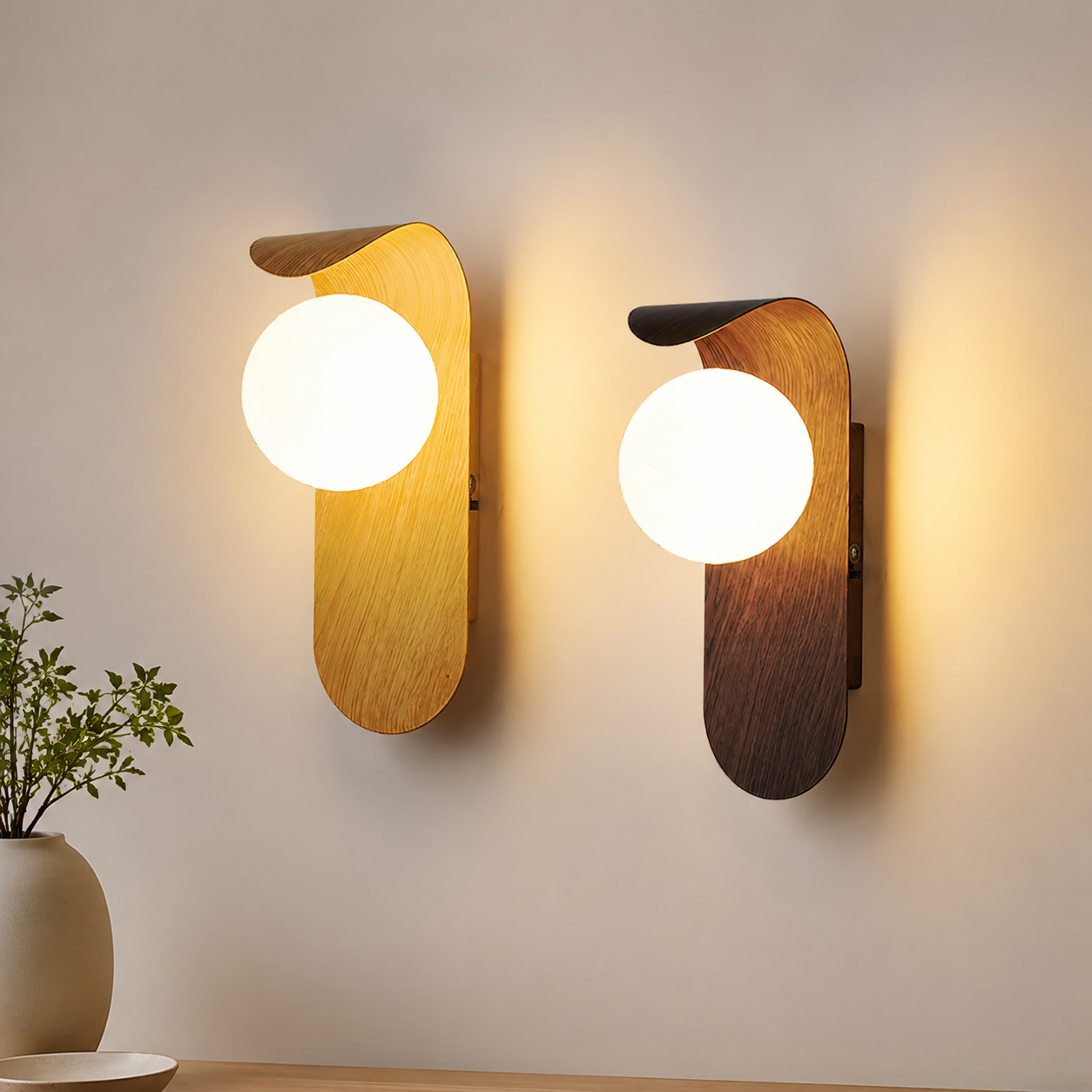 Light wood and walnut wall sconce pair glowing on a neutral wall.