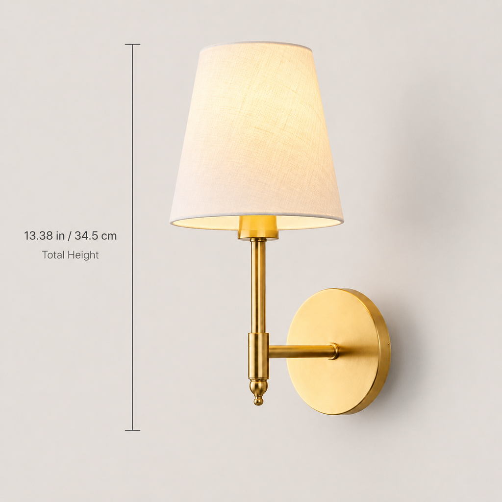 Gold wall sconce with white fabric shade shown with product dimensions.