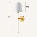 Gold wall sconce with white pleated shade shown with product dimensions.