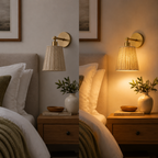 A wall-mounted lamp with a woven beige shade and gold-toned hardware shown in a bedroom setting, with the left side showing it unlit and the right side showing it glowing warm yellow. Bed, nightstand, pillows, books, and a vase are visible.