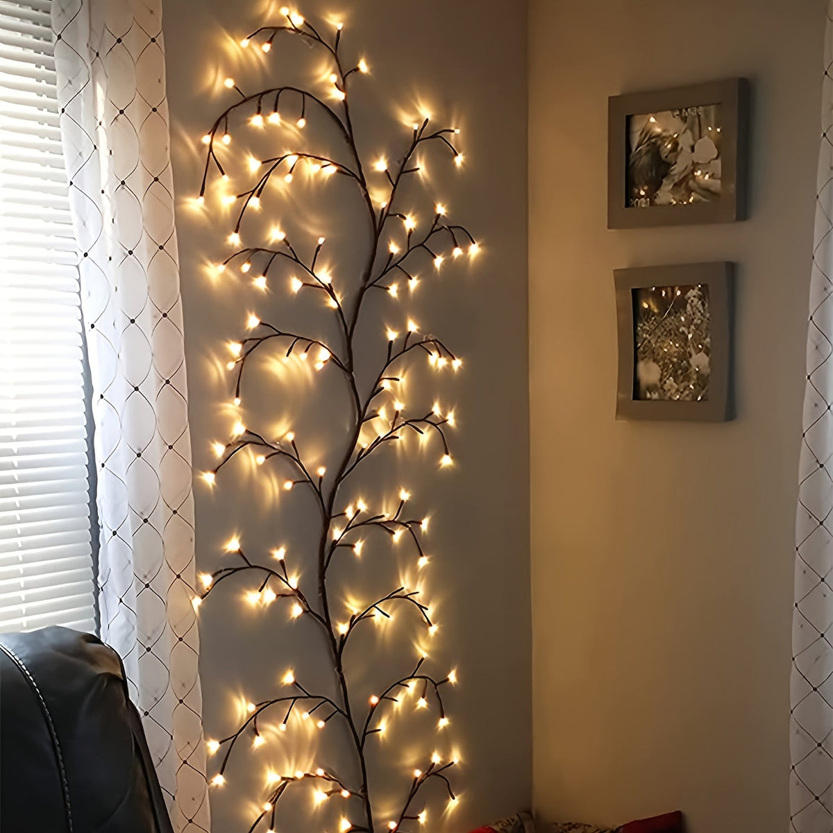 Willow vine fairy lights rise beside a window and curtain.