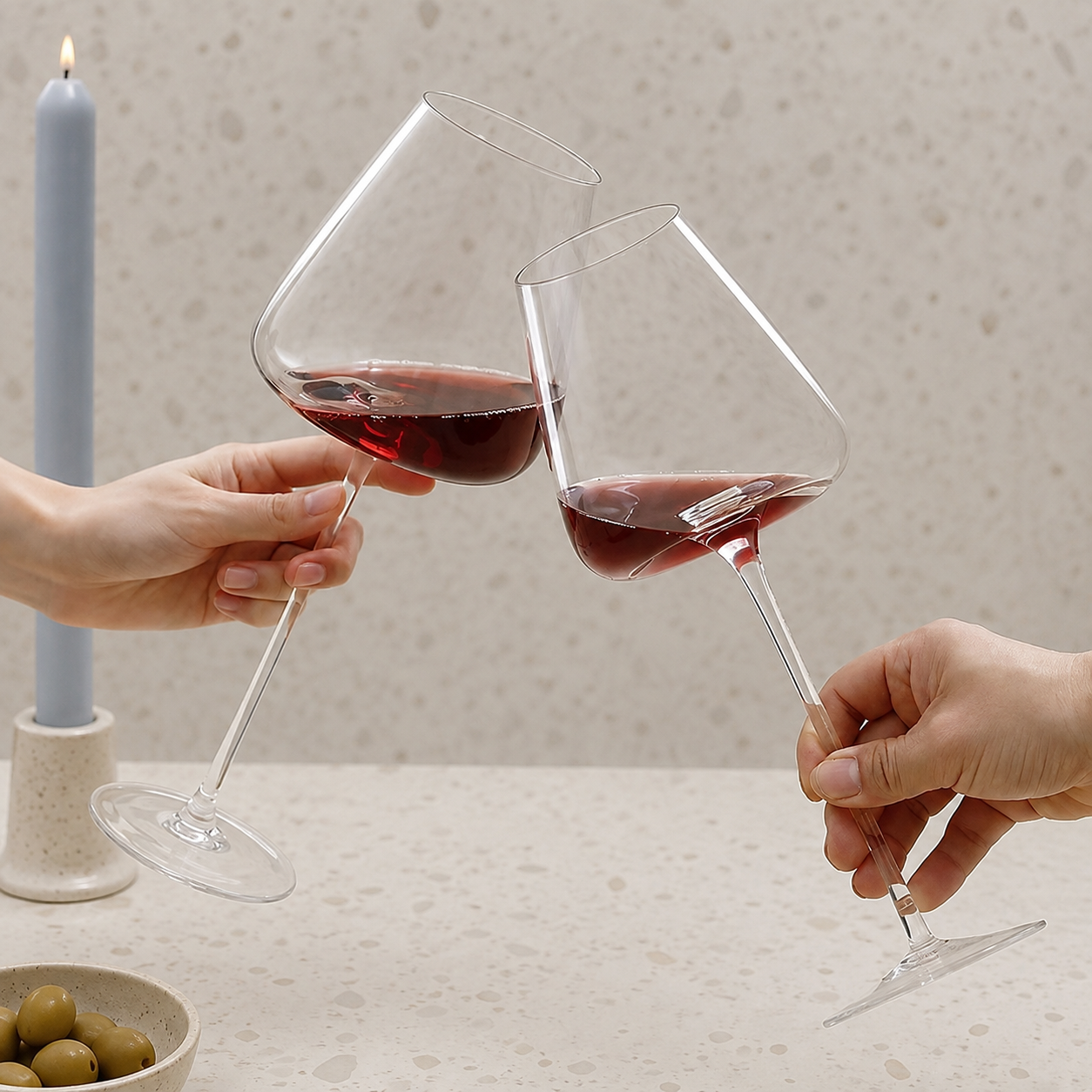 Wine glasses pair held together in a toast with red wine