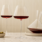 Wine glasses pair with red wine beside a matching crystal decanter