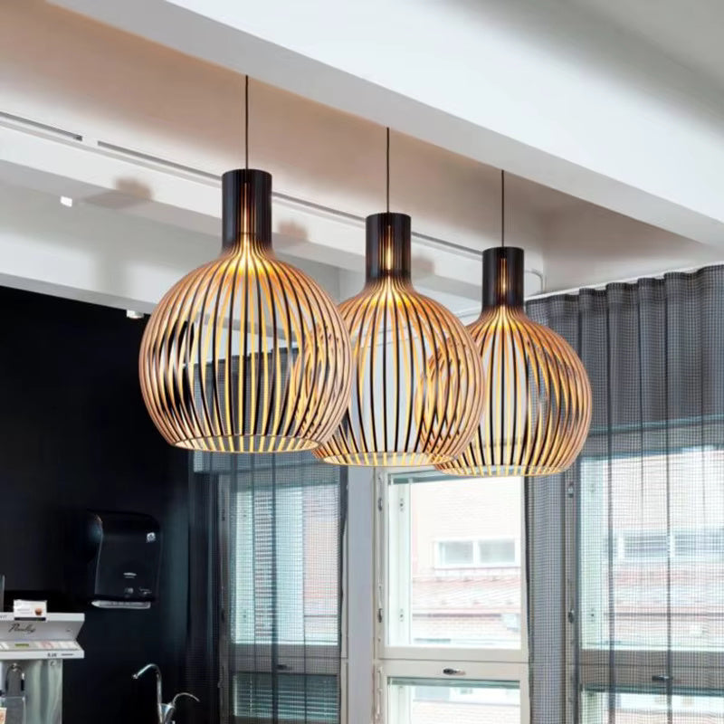 Wood pendant light arrangement with rounded slatted shades above a counter