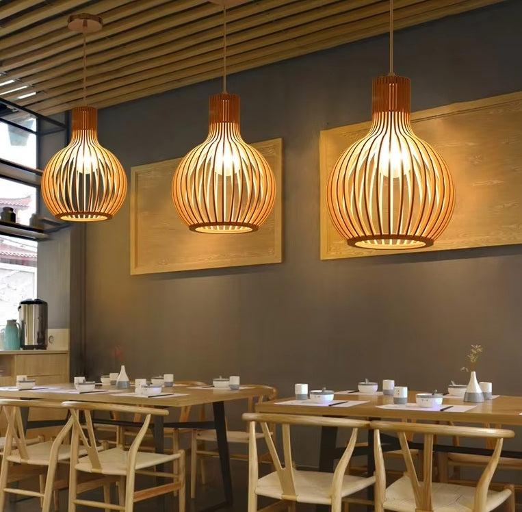 Wood pendant light arrangement hanging above restaurant tables