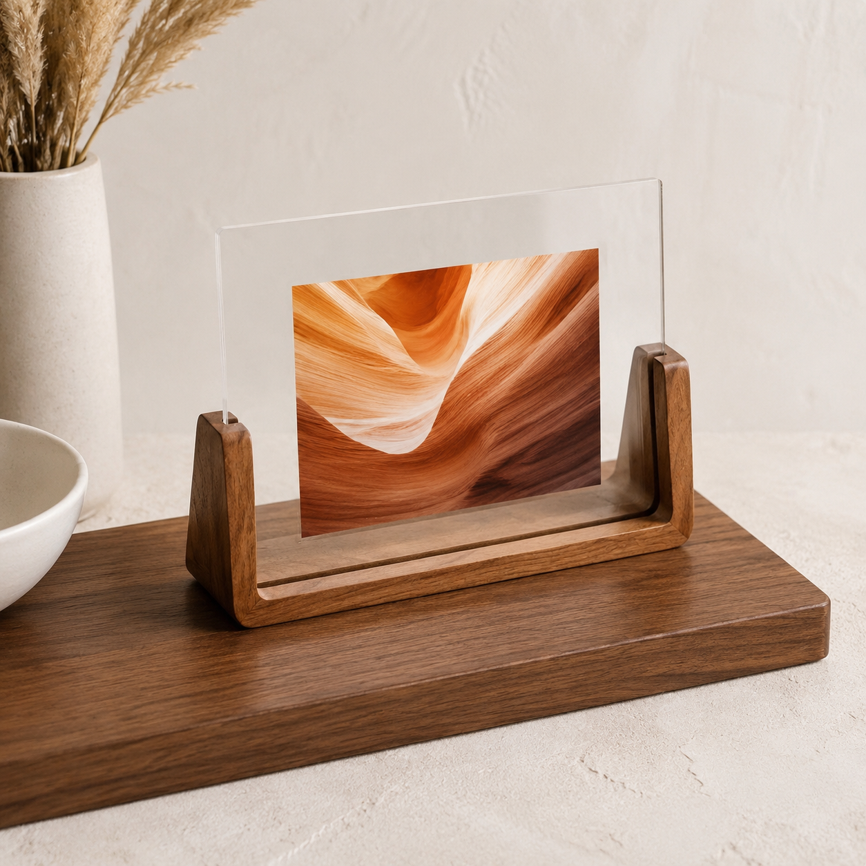 Horizontal acrylic photo frame with walnut base and orange abstract artwork.