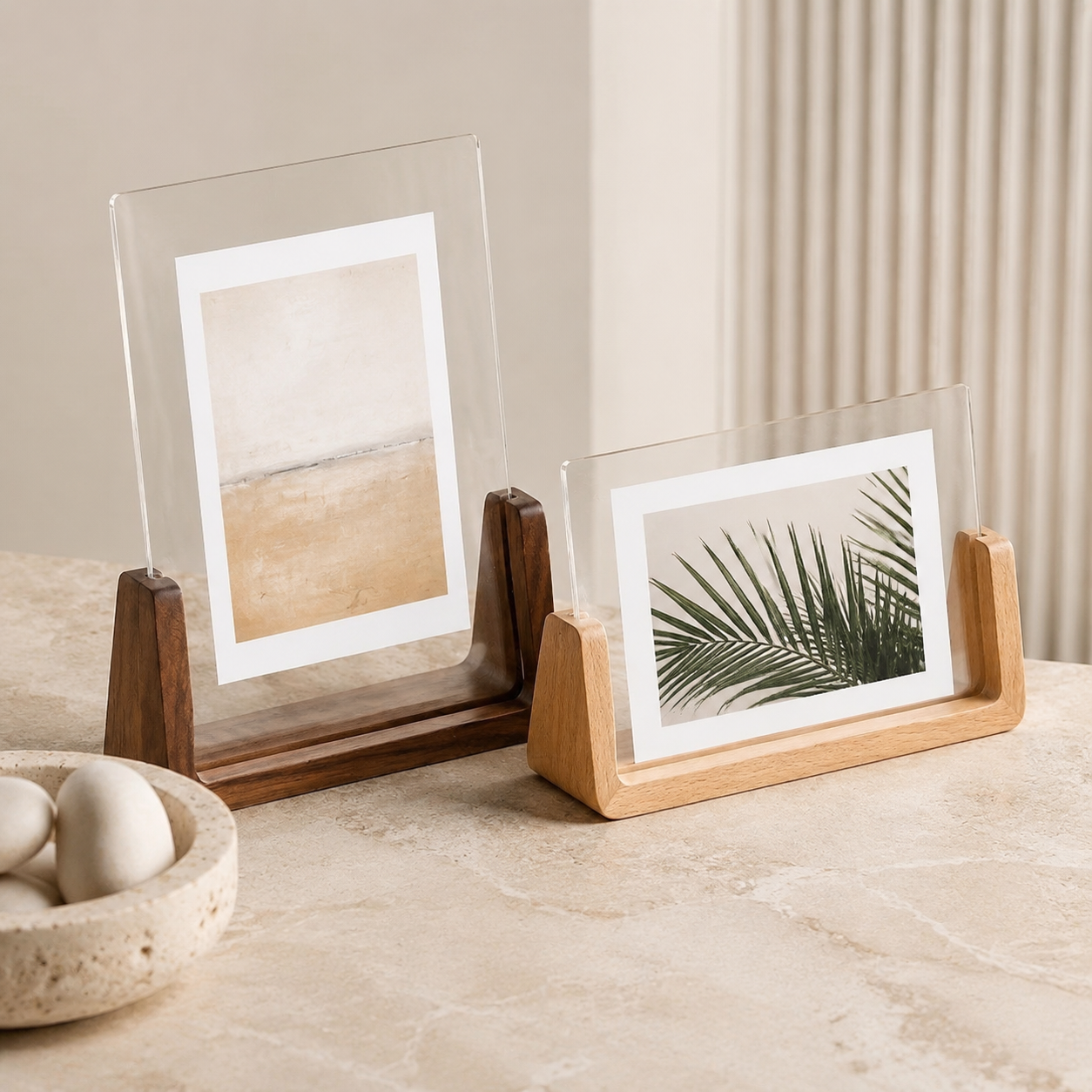 Vertical and horizontal acrylic photo frame styles displayed together on stone.