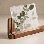 Horizontal acrylic photo frame with walnut base and a botanical print.