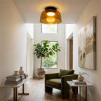 Green layered ceiling light in a light-filled sitting room.