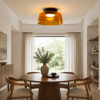 Green ceiling light over a compact dining setting.