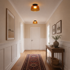 Orange ceiling lights along a bright hallway.