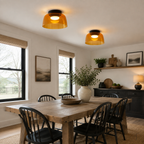 Pair of green ceiling lights above a modern dining table.