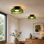 Green double-layer ceiling light in a modern room.