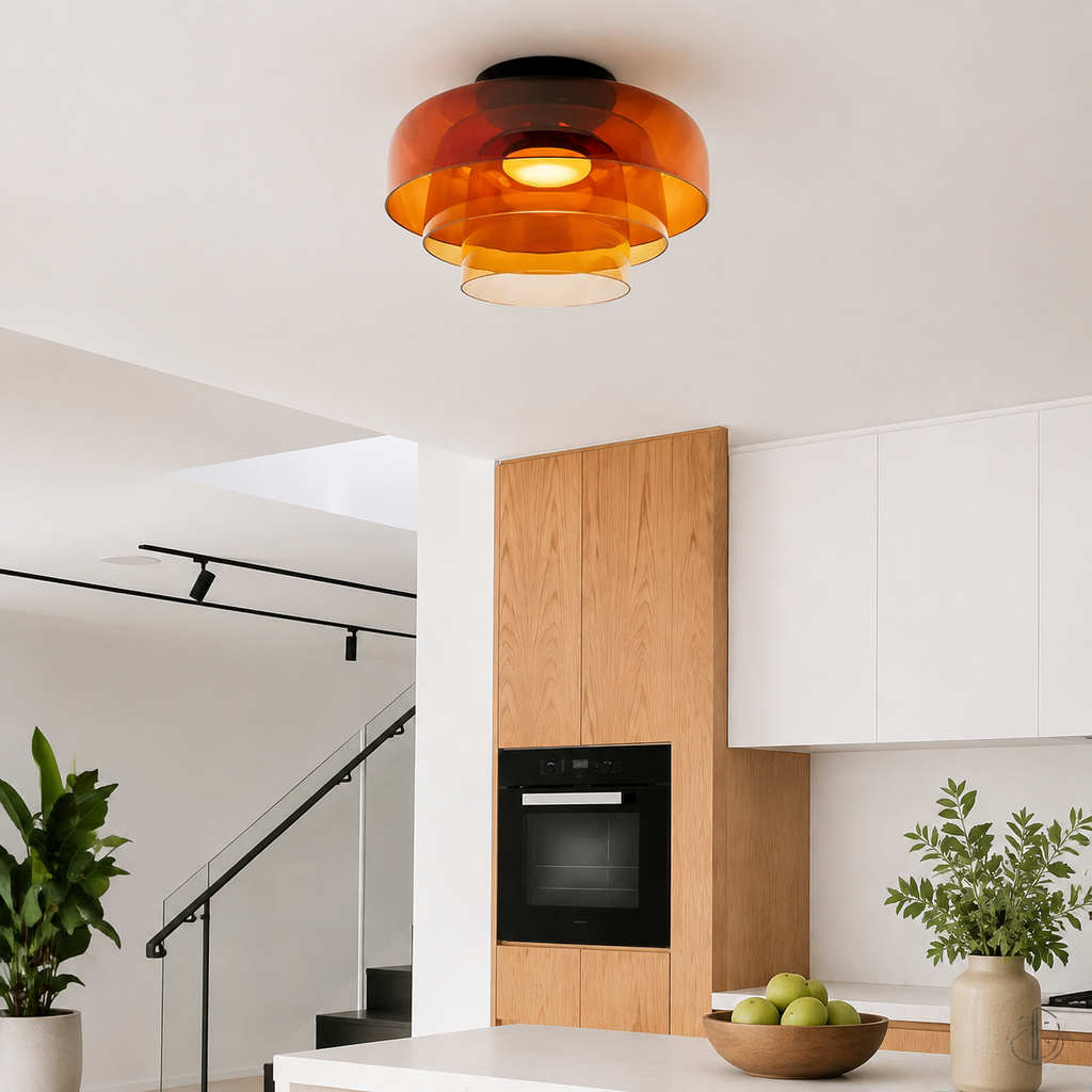 Orange three-layer ceiling light in a modern kitchen.